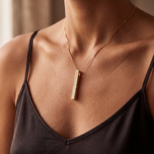 Model wearing the April Daisy birth flower necklace in 14K gold plated